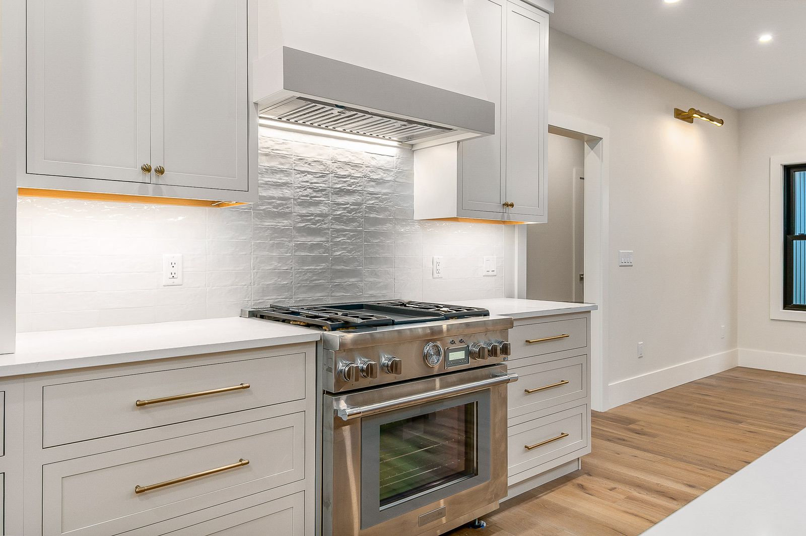 Kitchen detail with a professional stainless range and patterned tile backsplash - a River Birch Builders home in the New Hampshire Seacoast